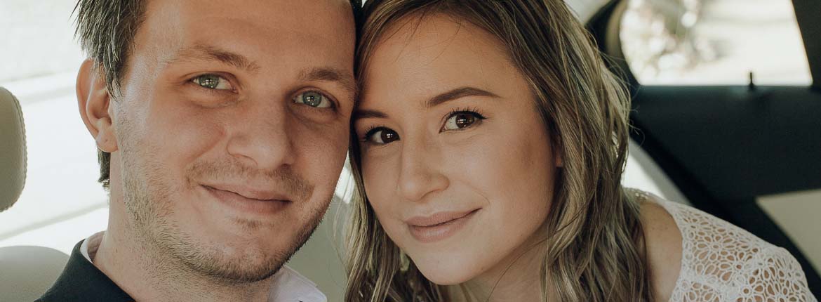 The Bride and Groom have faces glued together tightly side by side