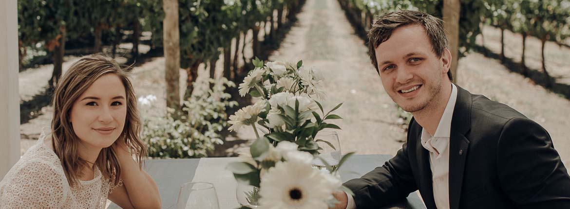 The bride and groom are seated at the table, carefully decorated with flowers for the special lunch